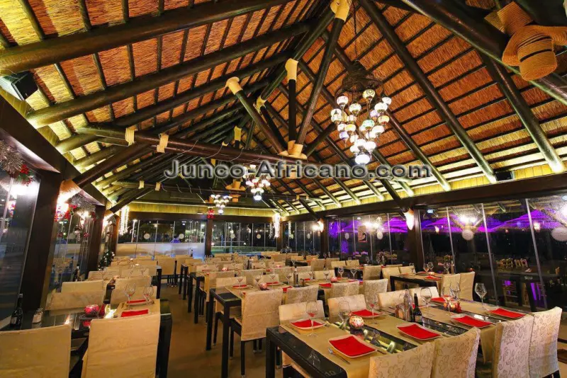 Restaurant dining room under an African thatch pergola in Granada